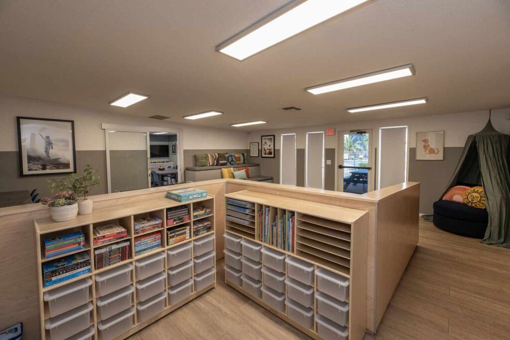 Kid club room with book cubbies and art supplies