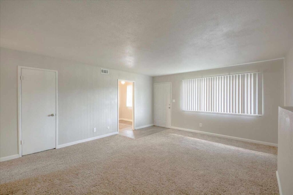 Living room with carpet and large window