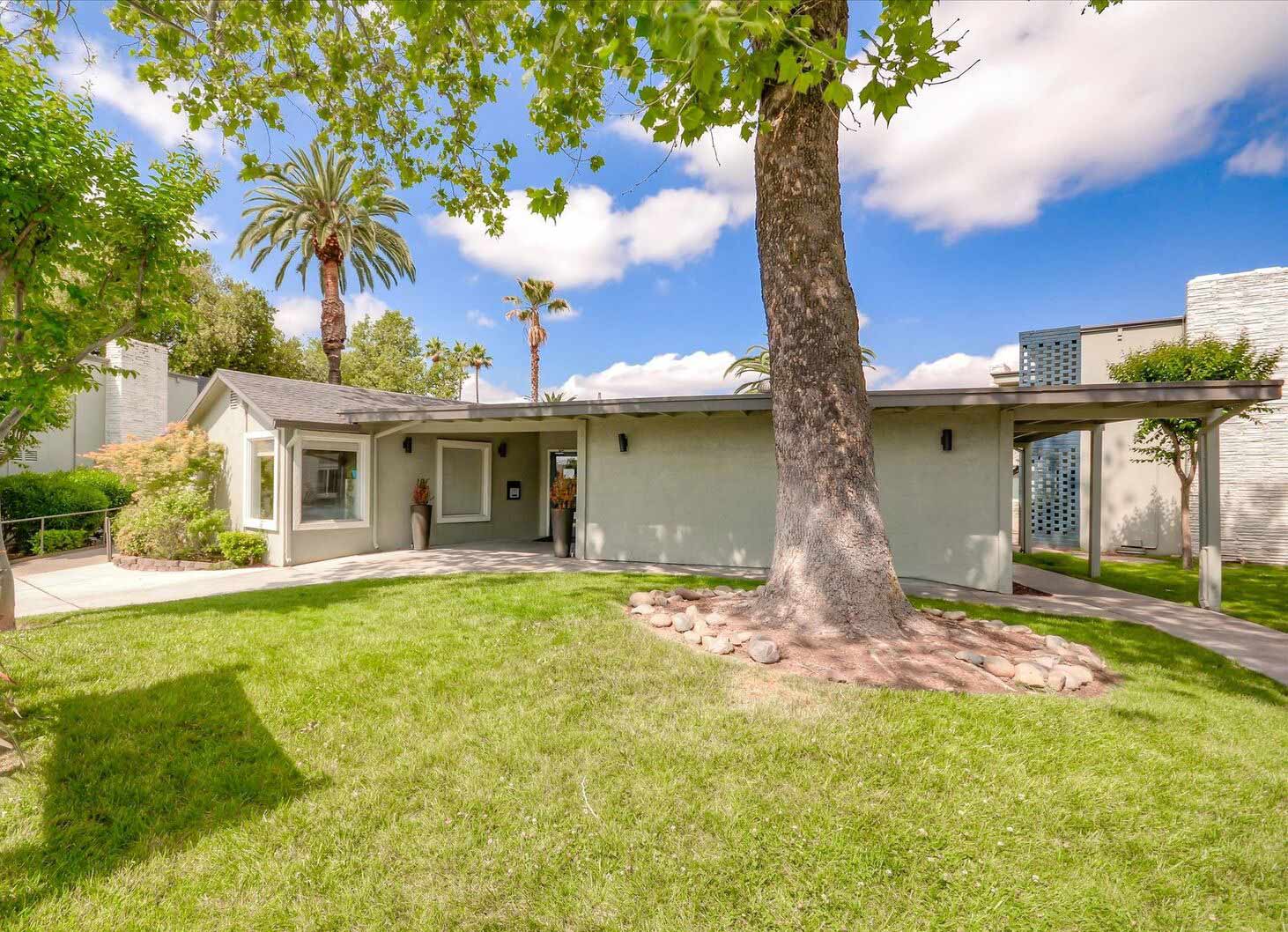 Leasing office exterior with large trees