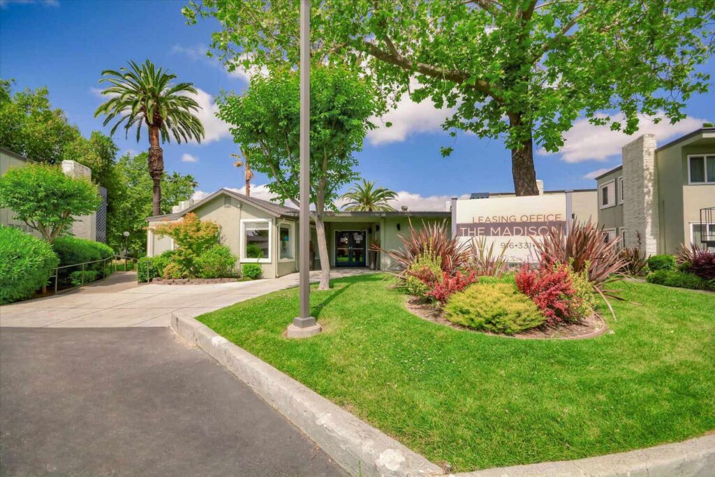 The Madison leasing office and property sign with lots of landscaping